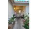 Charming entryway featuring double doors, decorative benches, and colorful plants at 6435 Heatherton Ave, Las Vegas, NV 89110