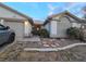 Charming home exterior featuring well-maintained landscaping, desert rock and a two-car garage under a tile roof at 6435 Heatherton Ave, Las Vegas, NV 89110
