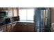 Kitchen featuring wooden cabinetry, granite countertops and stainless steel appliances at 6435 Heatherton Ave, Las Vegas, NV 89110