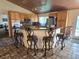 Kitchen area with barstool seating at the breakfast bar, wooden cabinets, and stainless appliances at 6435 Heatherton Ave, Las Vegas, NV 89110