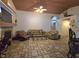 Spacious living room featuring tile flooring, cozy sofas, a fireplace, and archways at 6435 Heatherton Ave, Las Vegas, NV 89110