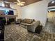 Comfortable living room with a fireplace, tile flooring, and open layout, perfect for relaxation and entertaining at 6435 Heatherton Ave, Las Vegas, NV 89110