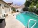 Inviting backyard pool with a spa, surrounded by lush landscaping and mountain views at 6435 Heatherton Ave, Las Vegas, NV 89110