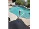 Sparkling pool with a tile waterfall feature and concrete surround offers a refreshing outdoor oasis at 6435 Heatherton Ave, Las Vegas, NV 89110