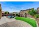 Beautifully landscaped backyard featuring a pool, green lawn, and comfortable lounge seating at 6442 American Eagle Ave, Las Vegas, NV 89131