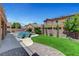 Backyard featuring a refreshing pool, grassy area, lounge chairs, and outdoor living at 6442 American Eagle Ave, Las Vegas, NV 89131
