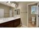 Bathroom with double sinks, cabinets, and a separate toilet area at 6442 American Eagle Ave, Las Vegas, NV 89131