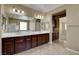 Luxurious bathroom featuring a double sink vanity, tile flooring, and a large mirror at 6442 American Eagle Ave, Las Vegas, NV 89131