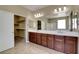 Bathroom features a dual sink vanity with dark wood cabinets, and a walk-in shower at 6442 American Eagle Ave, Las Vegas, NV 89131