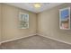 Bedroom featuring neutral walls, carpet, two windows and ceiling fan at 6442 American Eagle Ave, Las Vegas, NV 89131
