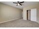 A spacious bedroom with neutral walls, carpet flooring, and closet with white doors at 6442 American Eagle Ave, Las Vegas, NV 89131