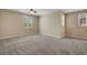 Expansive bedroom showcasing neutral carpet, fan, and windows, offering plenty of space and natural light at 6442 American Eagle Ave, Las Vegas, NV 89131