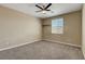 A neutral bedroom with carpet flooring, ceiling fan, and a bright window at 6442 American Eagle Ave, Las Vegas, NV 89131