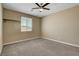 The bedroom is bright with neutral walls and has a ceiling fan and window at 6442 American Eagle Ave, Las Vegas, NV 89131