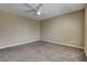 A carpeted bedroom with neutral colors, a ceiling fan, and natural light at 6442 American Eagle Ave, Las Vegas, NV 89131