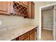 Butler's pantry with granite counters, wine rack, and shelving leading to a walk-in pantry at 6442 American Eagle Ave, Las Vegas, NV 89131