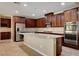 Gourmet kitchen featuring granite counters, stainless appliances and tile flooring at 6442 American Eagle Ave, Las Vegas, NV 89131