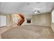 Open-concept living room features staircase, fireplace, and neutral carpet at 6442 American Eagle Ave, Las Vegas, NV 89131
