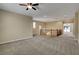 Spacious loft area featuring plush carpeting and a charming staircase, illuminated by a stylish ceiling fan at 6442 American Eagle Ave, Las Vegas, NV 89131