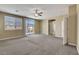 Bright loft area with carpet, natural light, ceiling fan, and access to a balcony at 6442 American Eagle Ave, Las Vegas, NV 89131