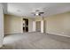 Spacious, carpeted loft featuring a ceiling fan, neutral paint, and access to other rooms at 6442 American Eagle Ave, Las Vegas, NV 89131