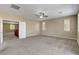 Large, carpeted loft featuring abundant natural light, a ceiling fan, and an open doorway at 6442 American Eagle Ave, Las Vegas, NV 89131