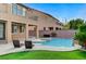 Backyard featuring a sparkling pool with lounge chairs, lush lawn, and outdoor seating at 6442 American Eagle Ave, Las Vegas, NV 89131