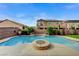 Inviting backyard pool with a fire pit, lush landscaping, and patio perfect for outdoor entertaining at 6442 American Eagle Ave, Las Vegas, NV 89131