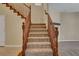 Carpeted staircase featuring wooden railings leading to the upper level at 6442 American Eagle Ave, Las Vegas, NV 89131