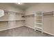 Spacious walk-in closet with carpet flooring, shelving, and closet rods for organization at 6442 American Eagle Ave, Las Vegas, NV 89131