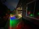Backyard at night with ambient lighting, manicured greenery, and desert landscaping at 6756 Millbury St, North Las Vegas, NV 89086
