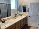 Bathroom featuring dual sinks, framed mirrors, and tiled floors at 6756 Millbury St, North Las Vegas, NV 89086