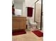 Bathroom featuring neutral tiles, a glass-enclosed shower, and light wood cabinetry at 6756 Millbury St, North Las Vegas, NV 89086