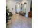 Inviting foyer showcasing neutral tiling, a bench with mirror, and an open archway leading to other spaces at 6756 Millbury St, North Las Vegas, NV 89086