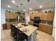 Open kitchen with a center island, pendant lighting, stainless steel appliances, and ample counter space at 6756 Millbury St, North Las Vegas, NV 89086