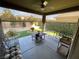 Inviting covered patio with comfortable seating and a view of the landscaped backyard at 6756 Millbury St, North Las Vegas, NV 89086