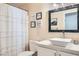 Bright bathroom with a vessel sink, framed mirror, and unique decor at 7705 Granberg Ct, Las Vegas, NV 89131