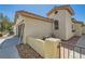 Side view of a well-maintained home with stucco siding at 7705 Granberg Ct, Las Vegas, NV 89131