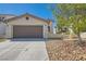 Charming single-story home with a well-maintained front yard and attached two-car garage at 7705 Granberg Ct, Las Vegas, NV 89131