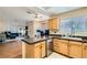 Bright kitchen with a breakfast bar that opens to the living area at 7705 Granberg Ct, Las Vegas, NV 89131