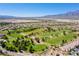 Panoramic aerial view of a golf course community with lush green fairways and mountain views at 7824 Homing Pigeon St, North Las Vegas, NV 89084