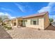 Low-maintenance backyard featuring a covered patio and desert landscaping, perfect for outdoor living at 7824 Homing Pigeon St, North Las Vegas, NV 89084