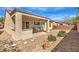Inviting backyard with a covered patio area and low-maintenance desert landscaping at 7824 Homing Pigeon St, North Las Vegas, NV 89084