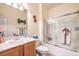 Bathroom with large mirror, neutral walls, shower with glass door, and white vanity at 7824 Homing Pigeon St, North Las Vegas, NV 89084