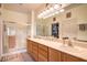 Well-lit bathroom featuring double sinks, a large mirror, and a glass-enclosed shower at 7824 Homing Pigeon St, North Las Vegas, NV 89084