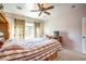 Cozy bedroom featuring a large bed, a ceiling fan, and neutral color palette at 7824 Homing Pigeon St, North Las Vegas, NV 89084