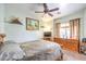 This bedroom features a ceiling fan, neutral walls, carpet, and window at 7824 Homing Pigeon St, North Las Vegas, NV 89084