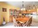 Cozy dining area featuring wood furniture, a decorative hutch, and bright yellow walls at 7824 Homing Pigeon St, North Las Vegas, NV 89084