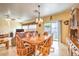Cozy dining area with a wood table, comfortable seating, and sliding door access at 7824 Homing Pigeon St, North Las Vegas, NV 89084
