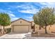 Charming single-story home with desert landscaping, attached two-car garage, and a tile roof at 7824 Homing Pigeon St, North Las Vegas, NV 89084